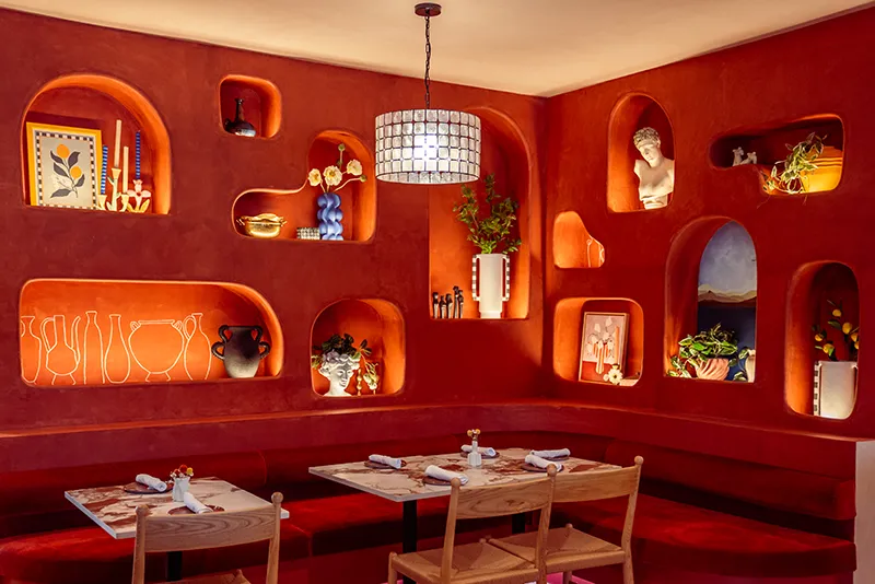 Clio's red dining room with arched shelving niches