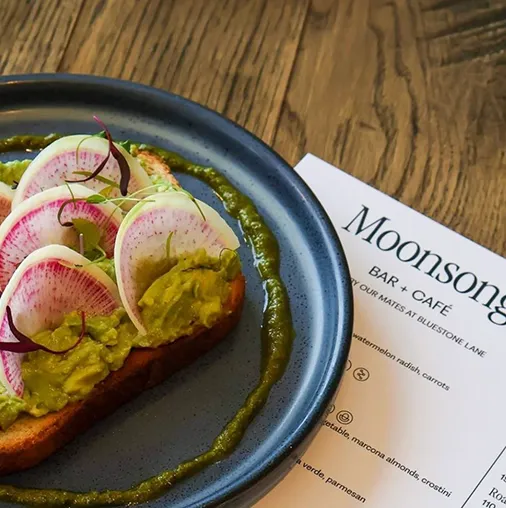 Avocado toast beside a Moonsong menu