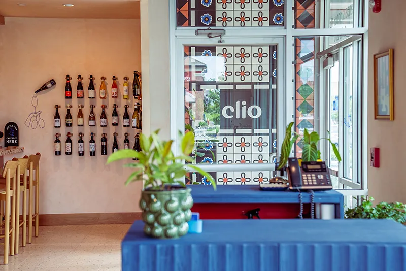 Clio's entry with patterned tile and a wine wall