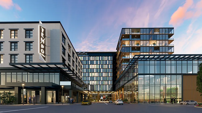 Rendering of a modern hotel at dusk with a glass-fronted entrance