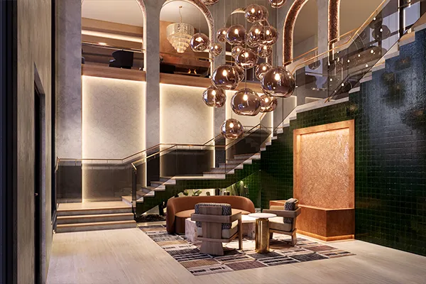 Lobby lounge at Uptown Tucson with arched ceilings, a sculptural bubble pendant chandelier, and a green tiled staircase.