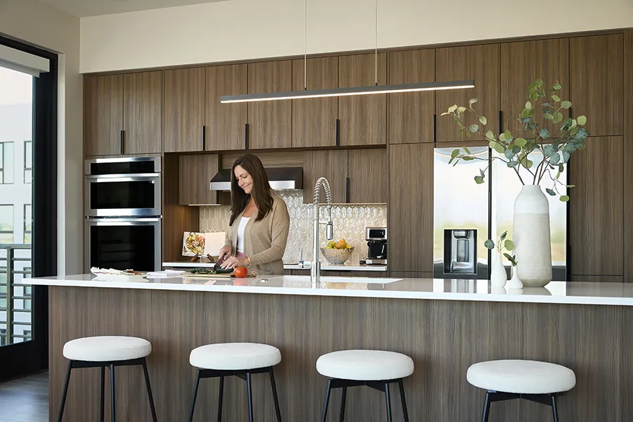Resident cooking in a modern kitchen with a large island