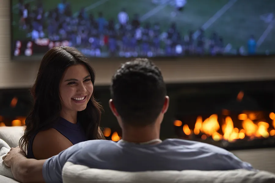 Couple relaxing by a fireplace in a residents' lounge